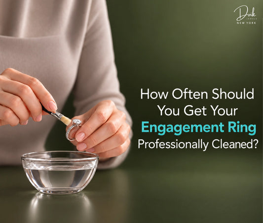 Woman cleaning an engagement ring using a small brush, from Dvik Jewels, demonstrating careful ring cleaning at home.