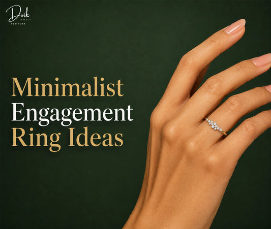 Delicate minimalist engagement ring displayed on a hand with Dvik Jewels branding and a dark green backdrop.