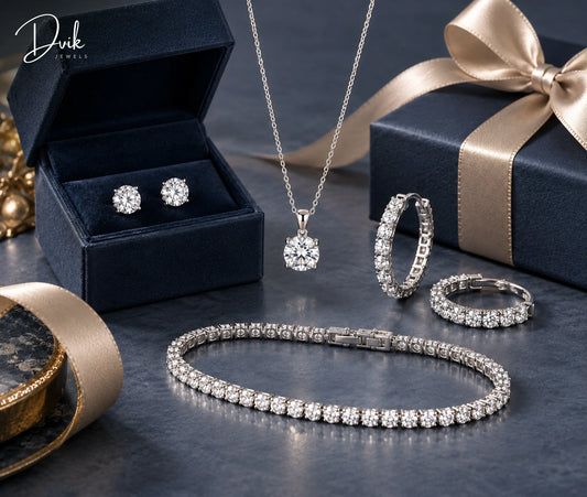 A matching diamond jewelry set including a necklace, tennis bracelet, stud earrings, and hoop earrings displayed with gift boxes.