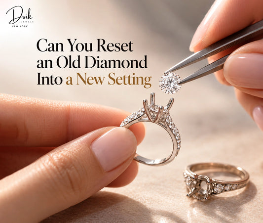 Loose diamond is held above a new ring setting by Dvik Jewels, while hands prepare to reset an older diamond ring nearby.