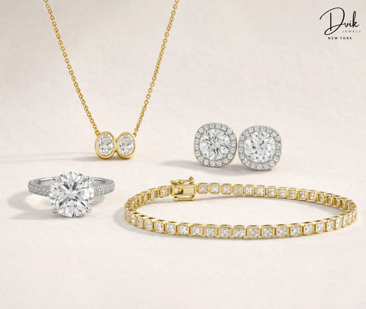 Dvik Jewels diamond ring, gold tennis bracelet, halo earrings, and double stone pendant necklace.
