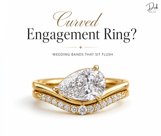 Gold pear shaped curved engagement ring with a matching diamond wedding band that sits flush by Dvik Jewels.