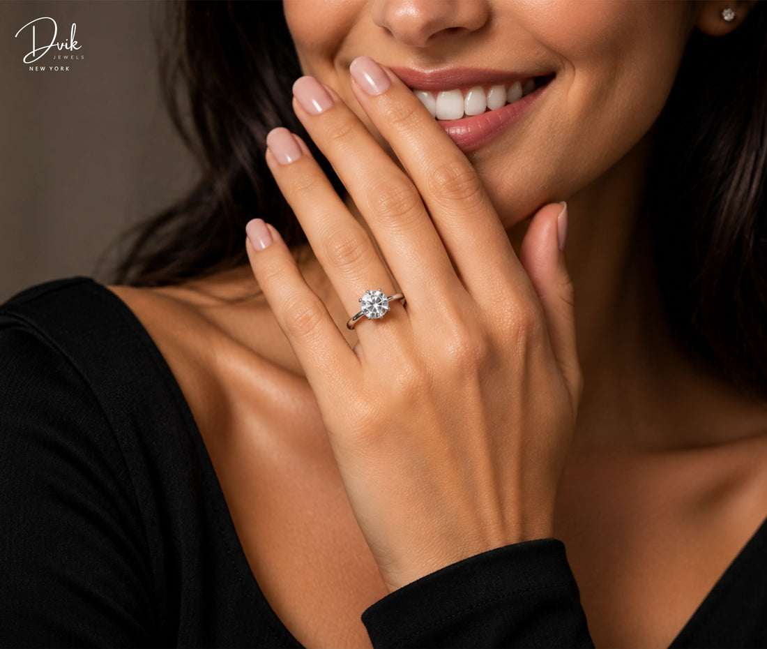 A model wearing a classic solitaire diamond engagement ring on her hand while smiling.