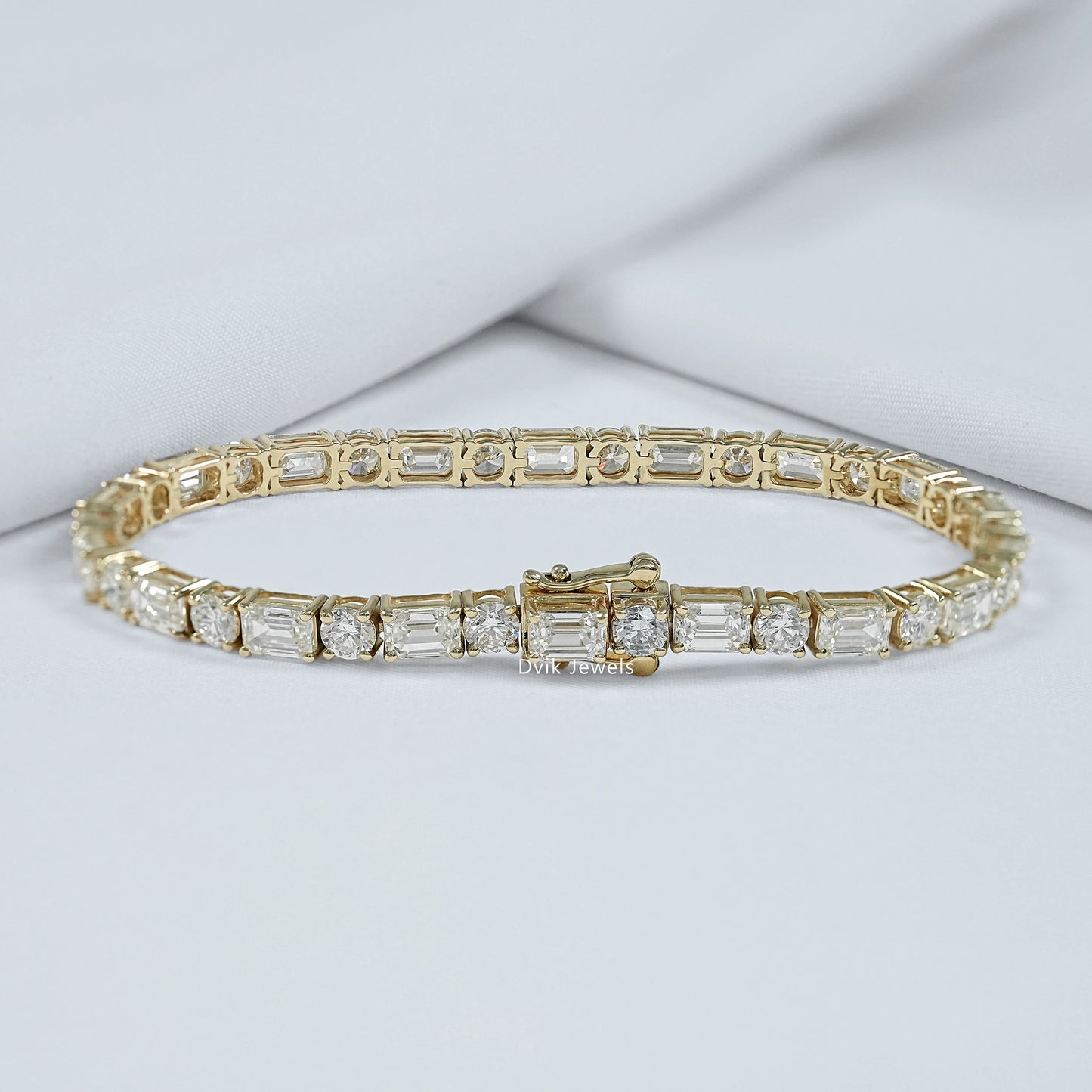 Back view of emerald cut tennis bracelet with round cut diamond showing the secure lock profile