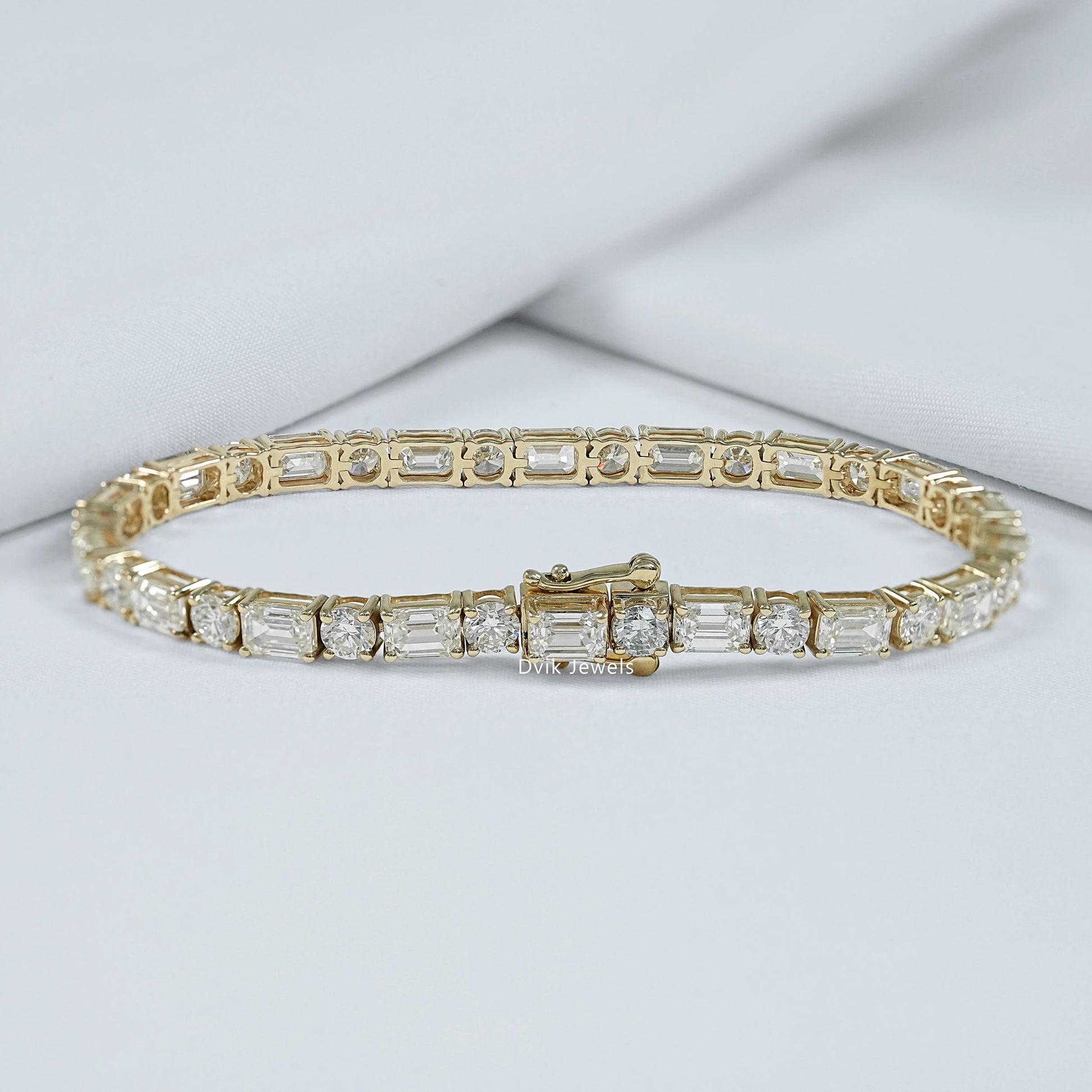 Back view of emerald cut tennis bracelet with round cut diamond showing the secure lock profile