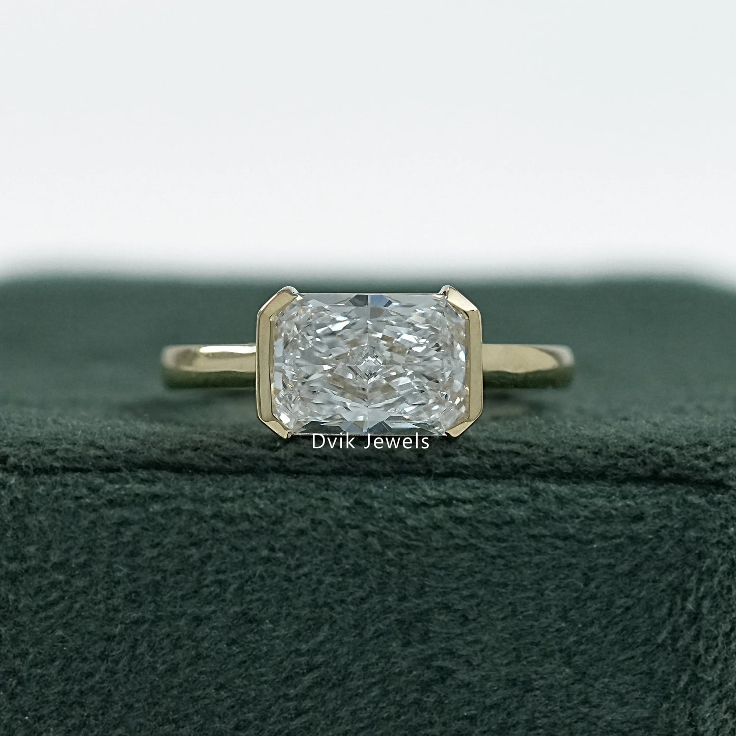 Radiant cut engagement rings bezel yellow gold front view on box