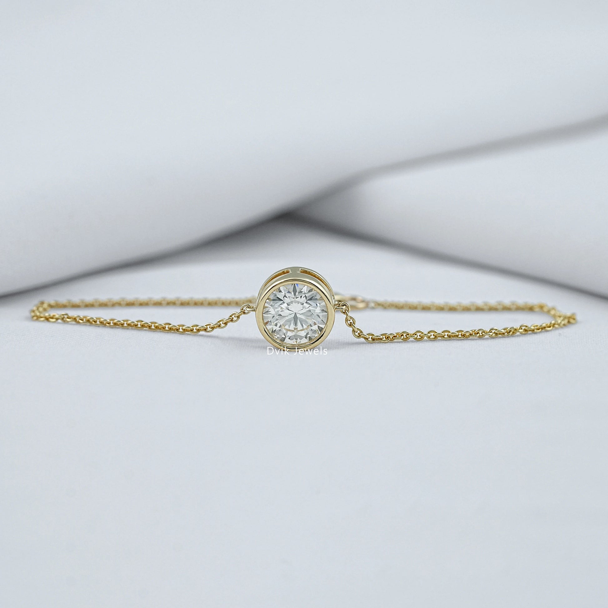 Bezel set diamond bracelet yellow gold front view on green box