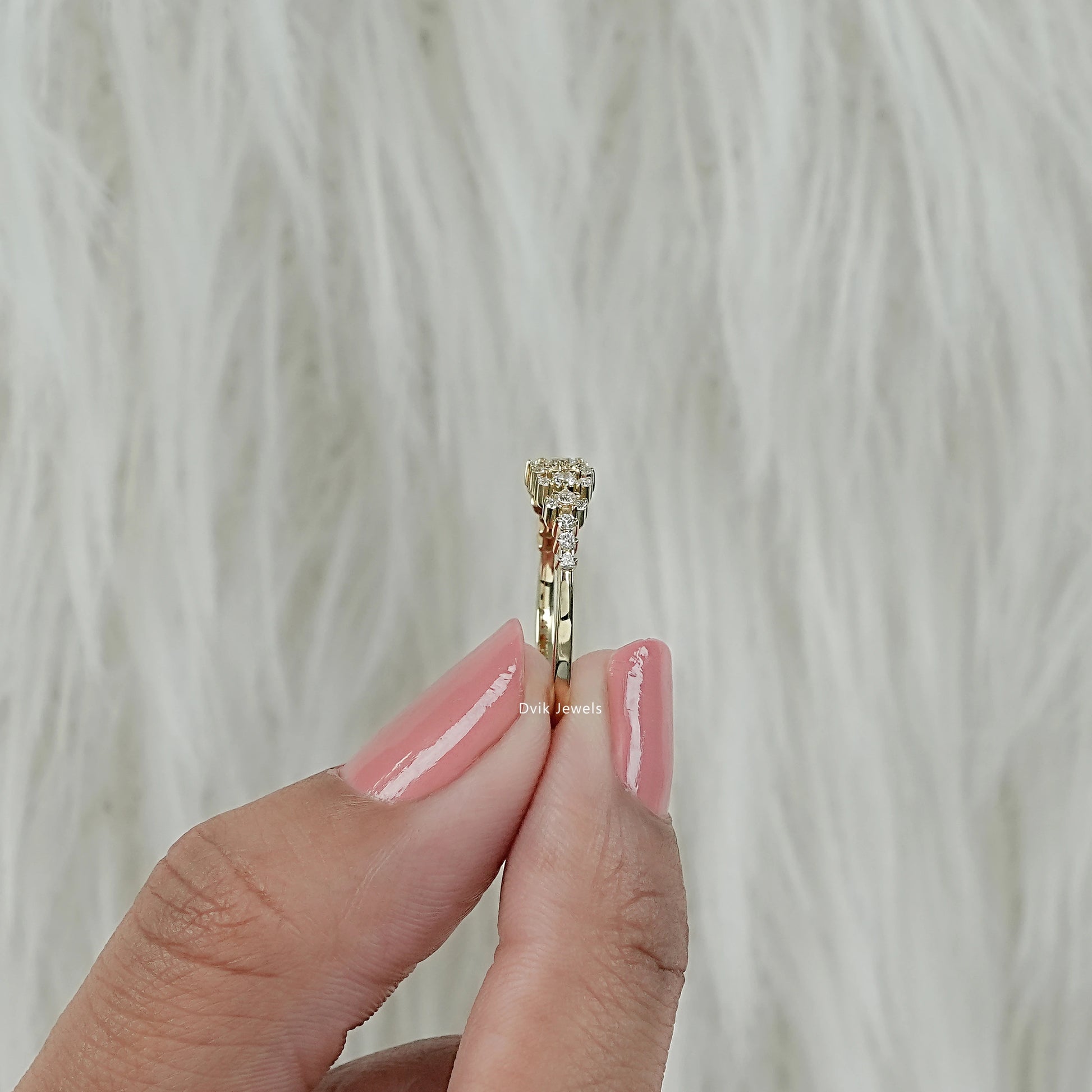 Graduated cluster serenity round diamond ring with side view held by women