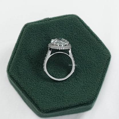 Oval engagement rings with halo displayed on a soft fabric for sharp detail