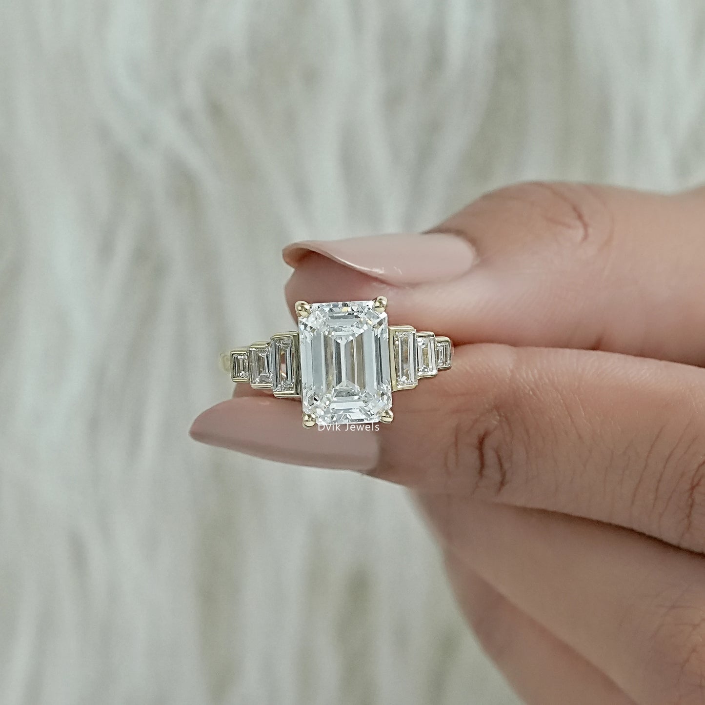 Emerald cut engagement rings yellow gold finish with a polished look.