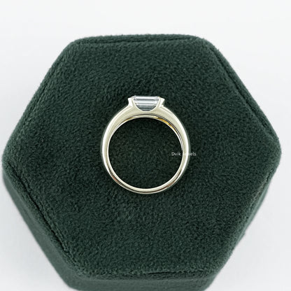 Emerald Cut wide band Solitaire engagement Ring held on jewelry box, ideal for gifting