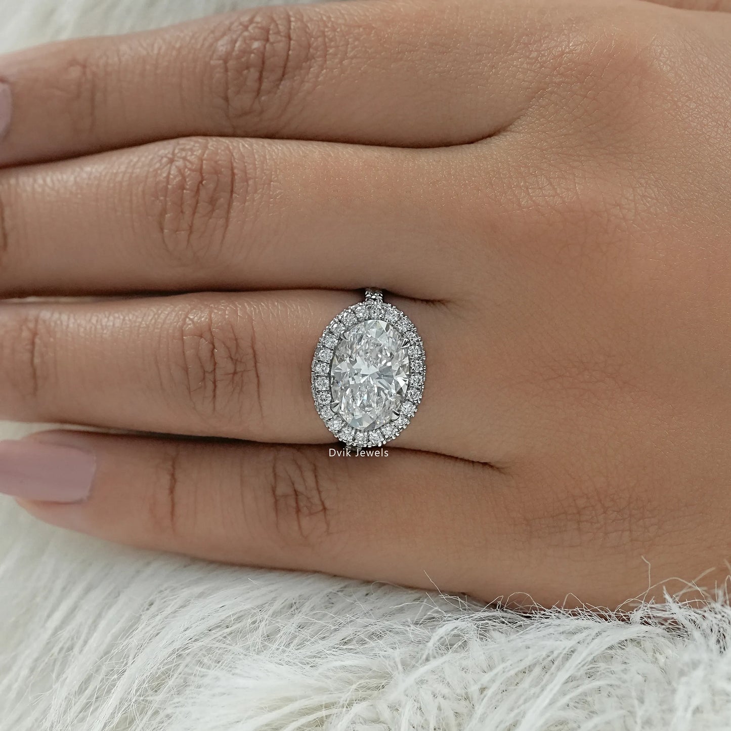 4 carat oval engagement ring displayed on a soft fabric for a premium view