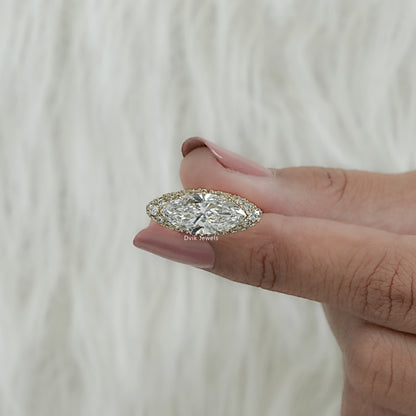 Women hold marquise diamond engagement ring pave band to display side band detailing