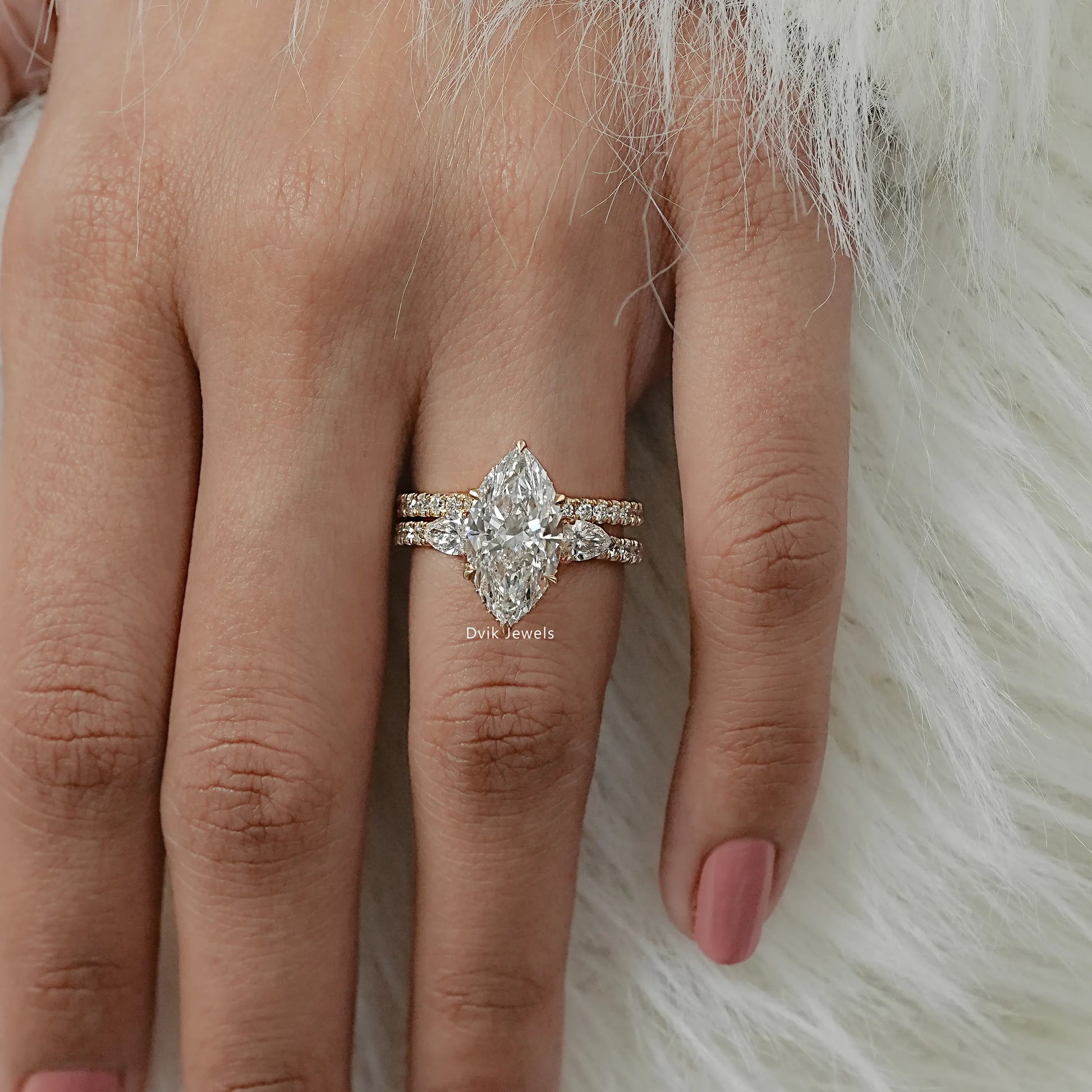 Top view of marquise diamond bridal set with pave-set lab diamond wedding bands worn by women