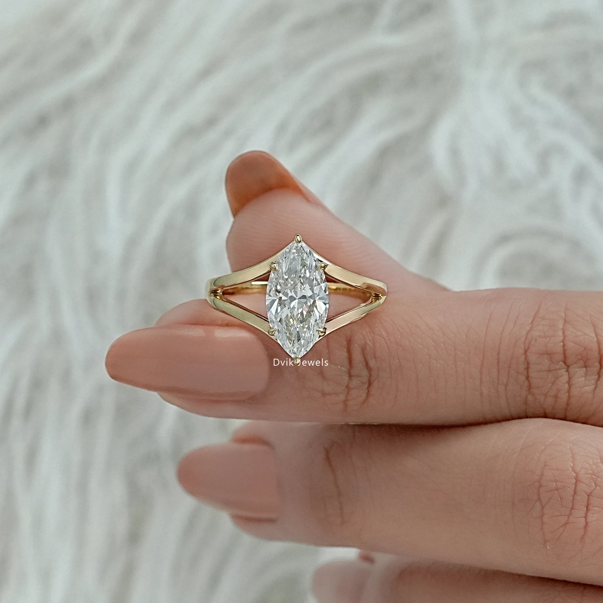 Lab grown marquise diamond ring worn on a hand showing the bridal design
