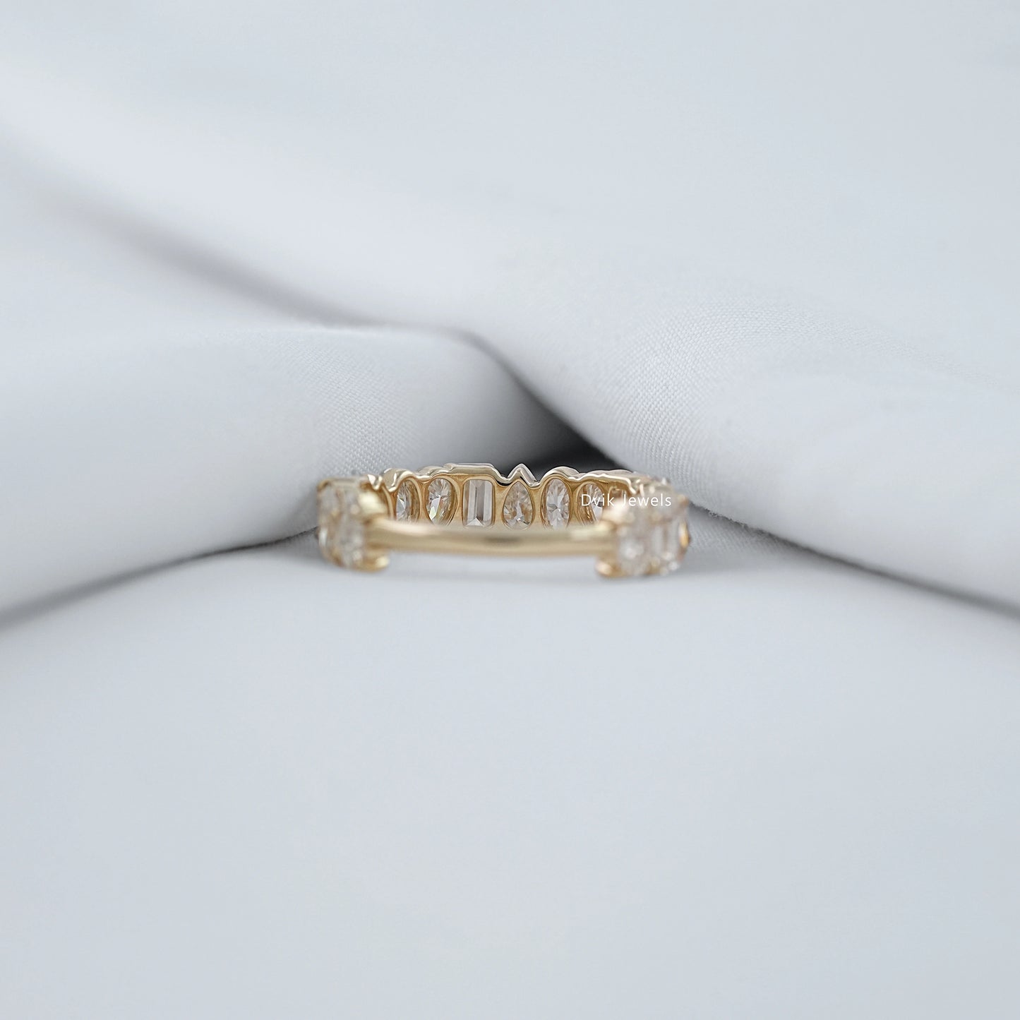 Back view of mixed diamond eternity band showing prong setting and slim band