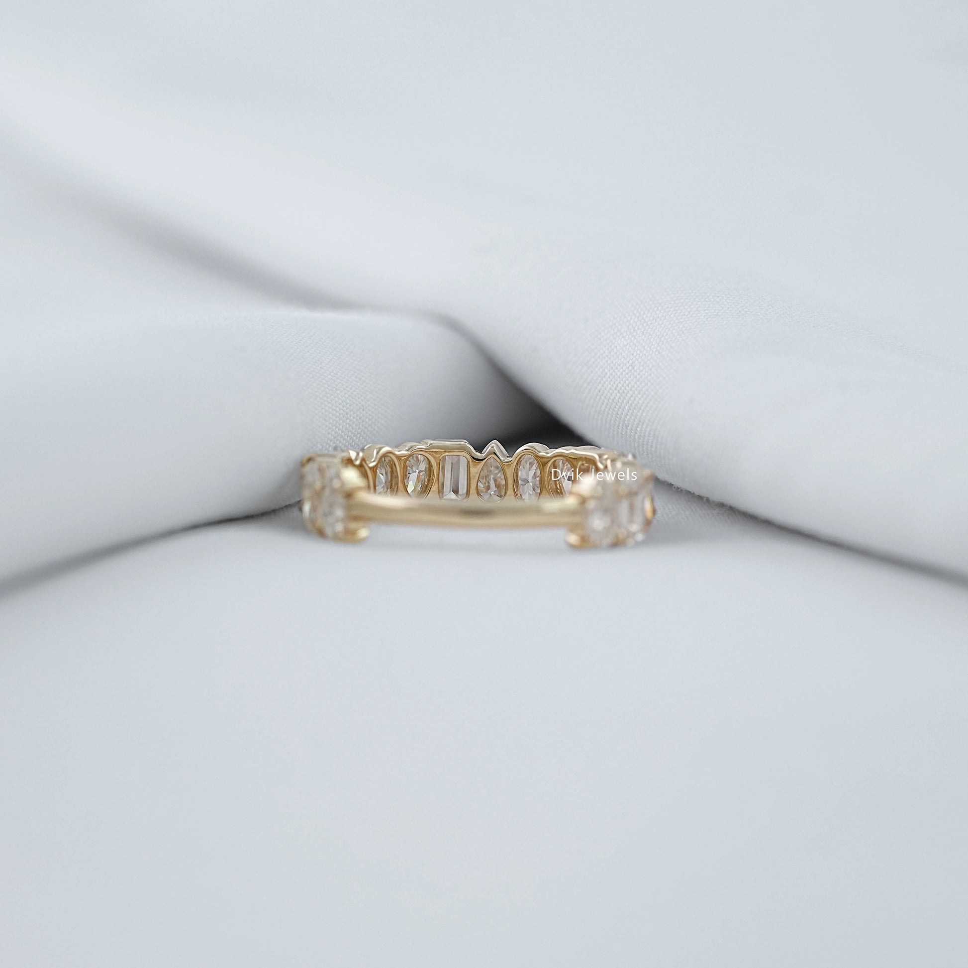 Back view of mixed diamond eternity band showing prong setting and slim band