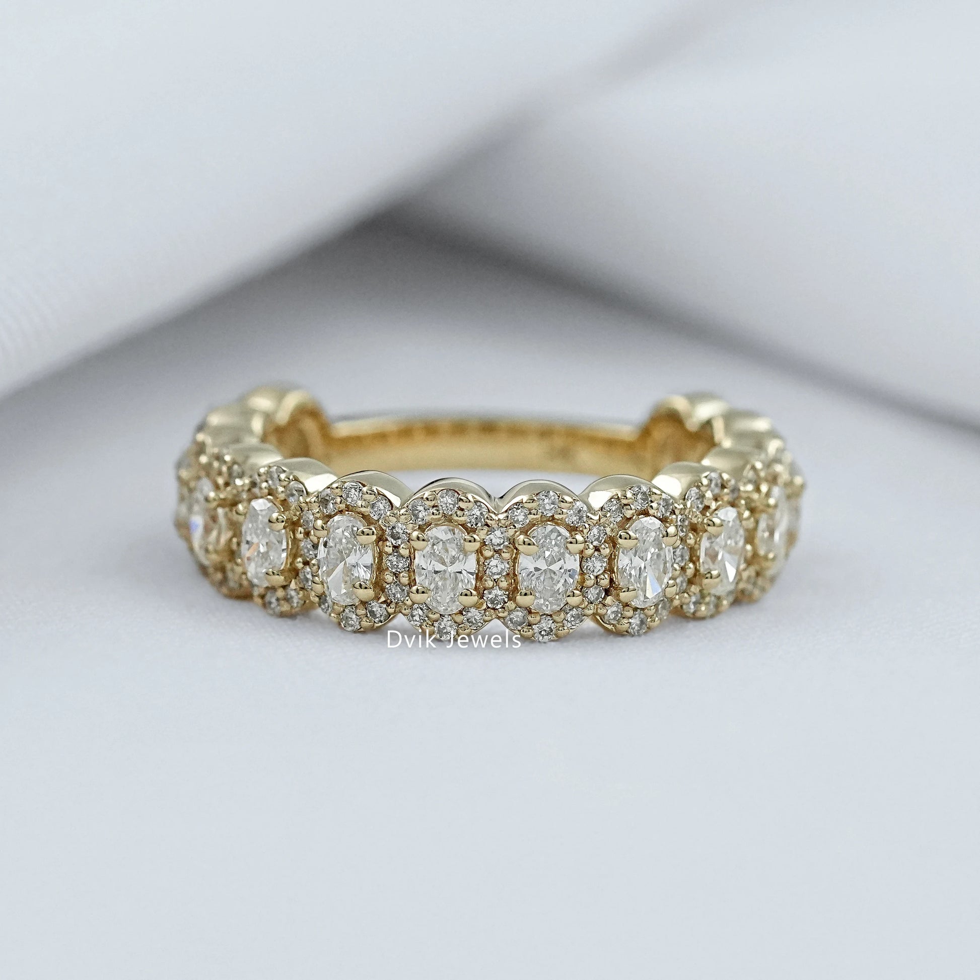 Oval halo with wedding band in 14k yellow gold cluster style.