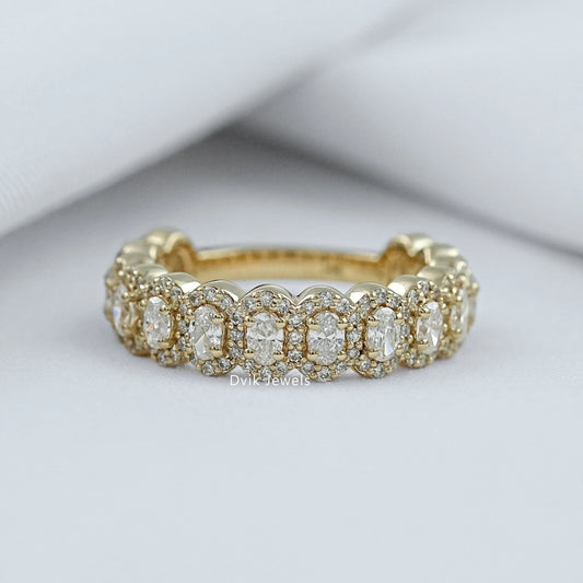 Oval halo with wedding band in 14k yellow gold cluster style.
