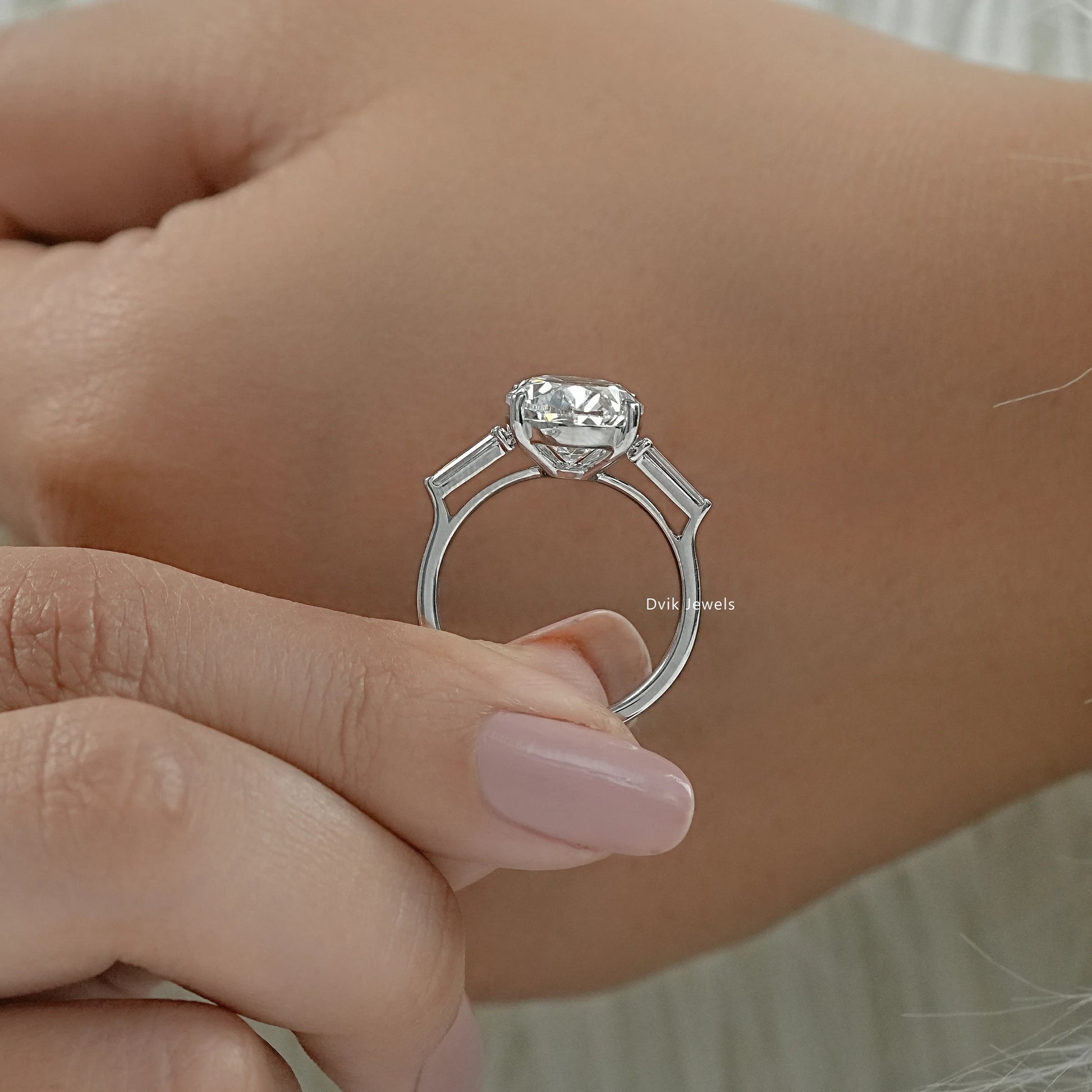 Oval lab diamond engagement ring with baguette accents close up view