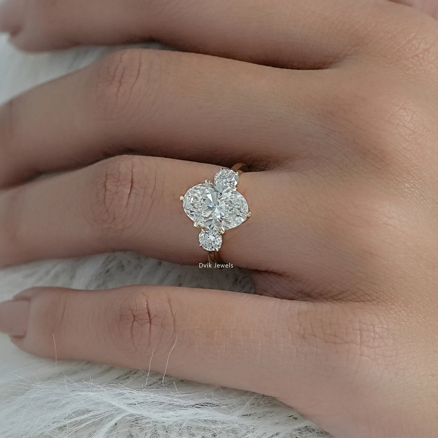 3 stone oval engagement ring lab grown diamonds held to show the profile