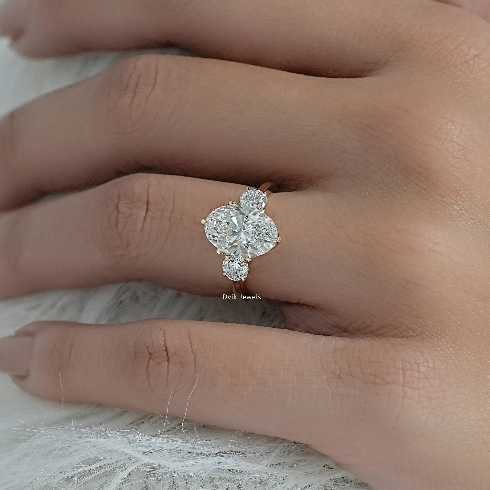 3 stone oval engagement ring lab grown diamonds held to show the profile