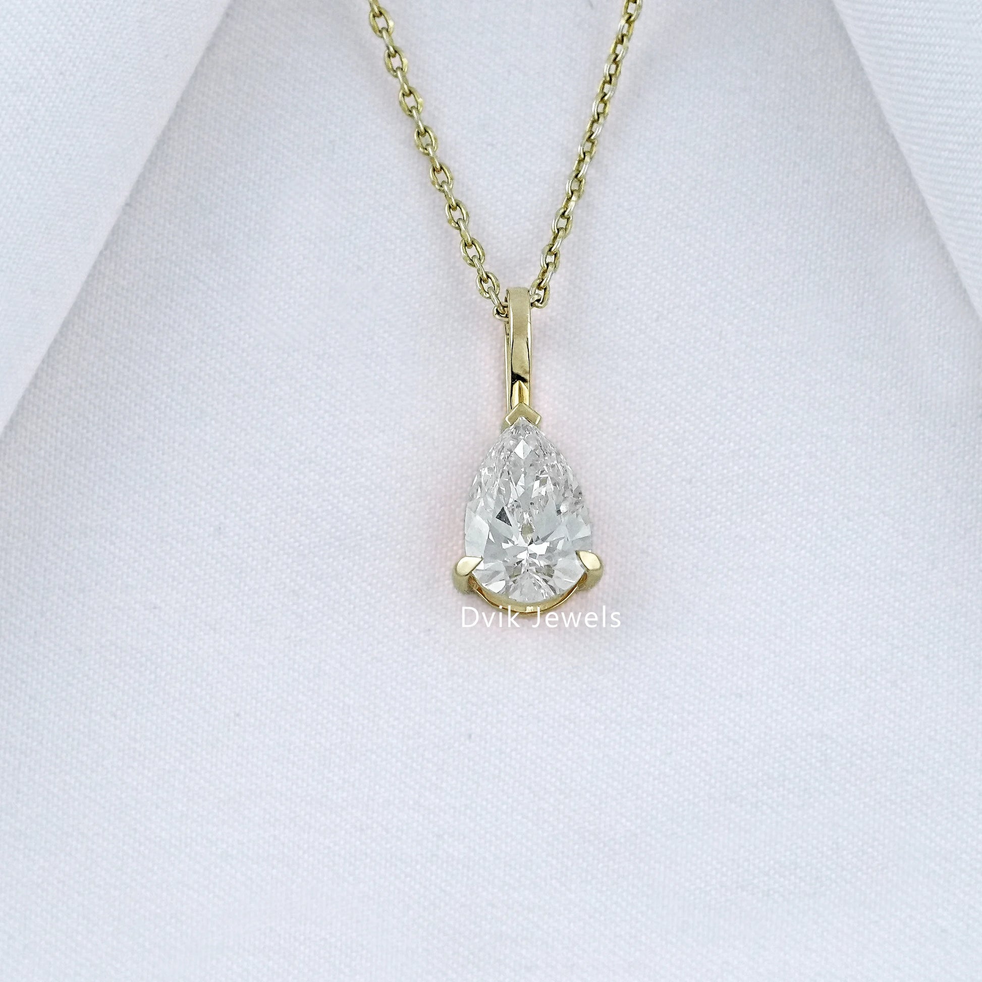 Dvik Jewels display lab grown pear cut solitaire diamond pendant in yellow gold