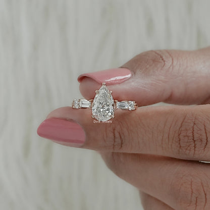 Front view of five-stone lab diamond ring with pear and baguette accents