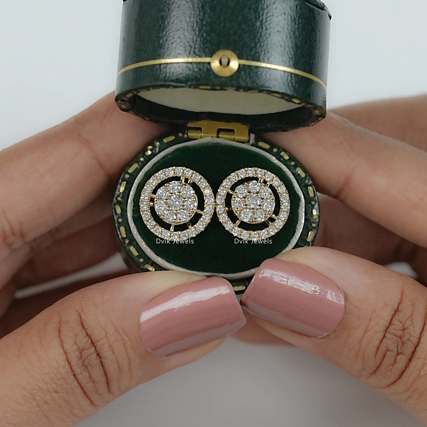 Round cut lab diamond halo cluster stud earrings on jewelry box by Dvik Jewels
