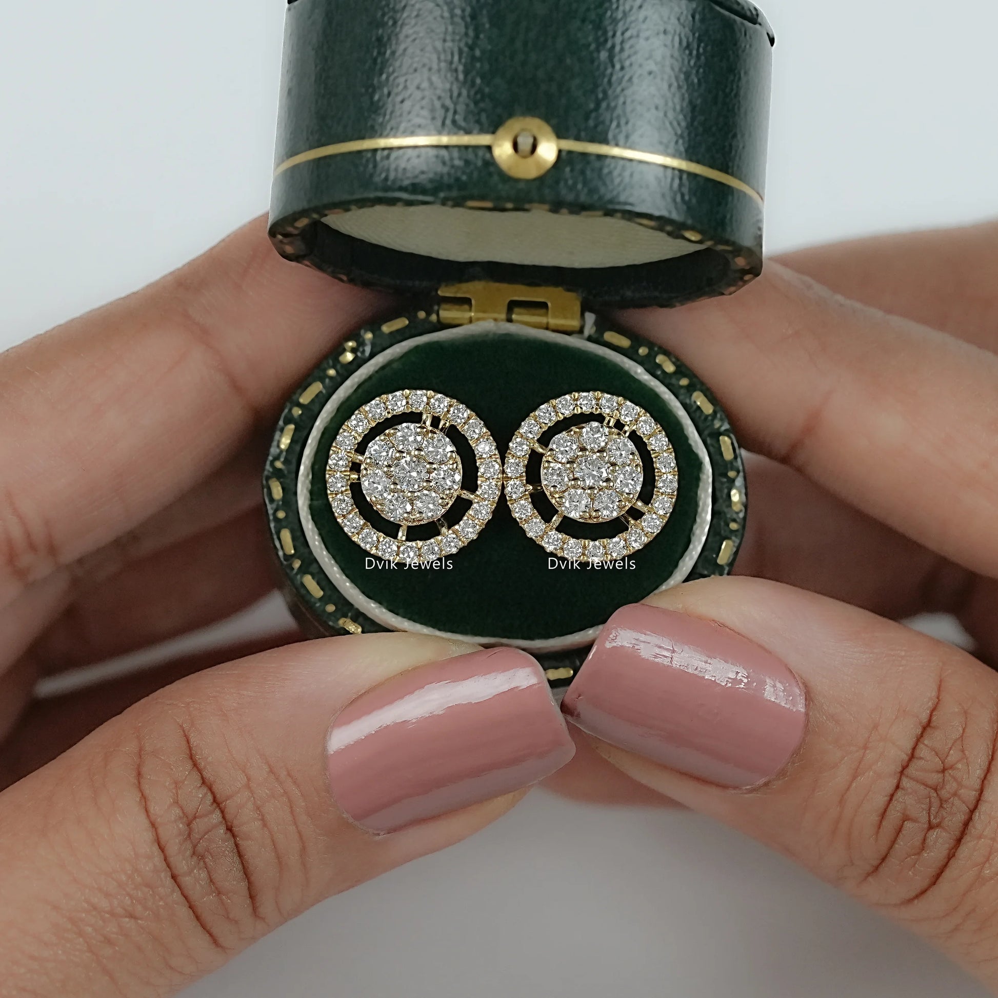 Round cut lab diamond halo cluster stud earrings on jewelry box by Dvik Jewels