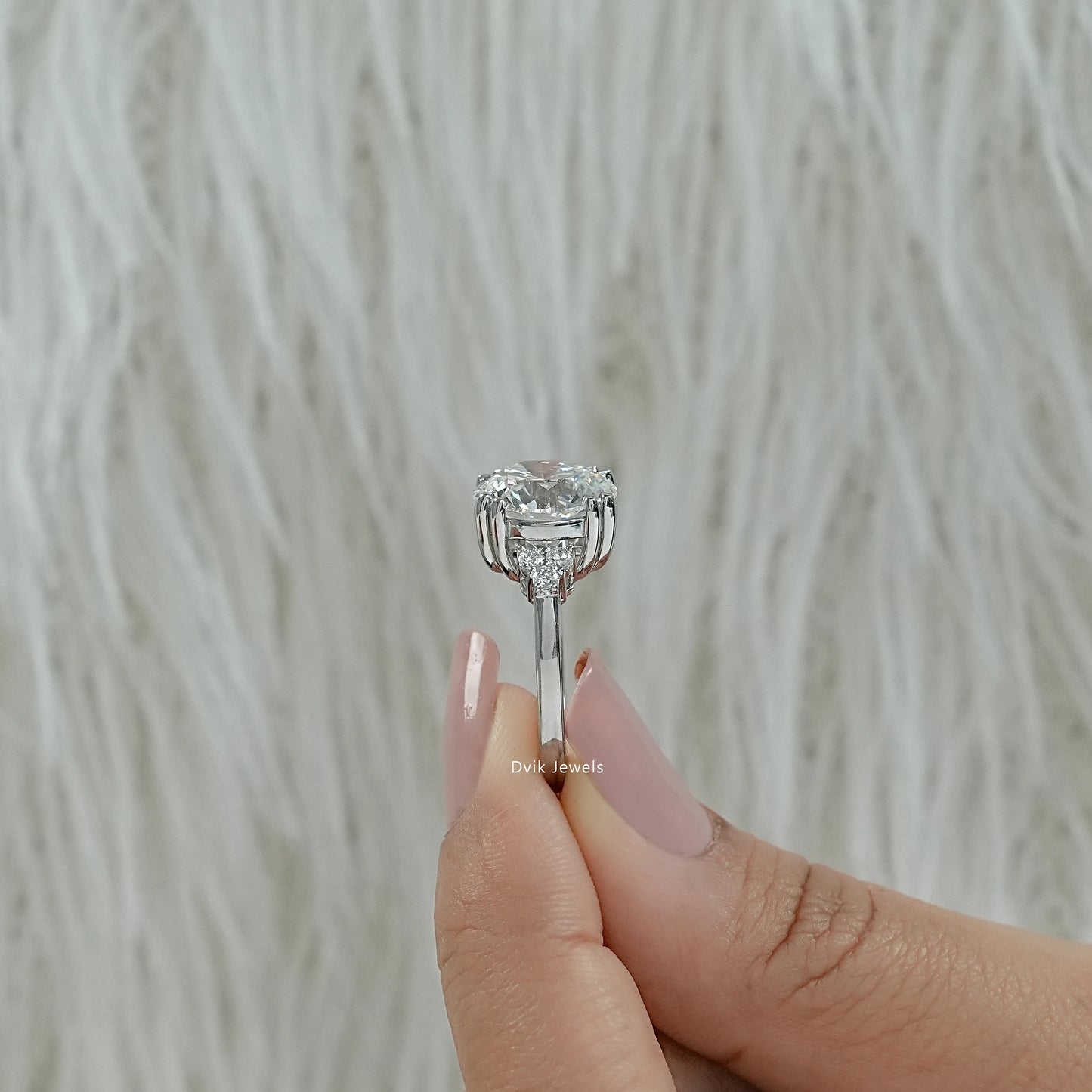 Round diamond cluster ring with double prong engagement ring close up view