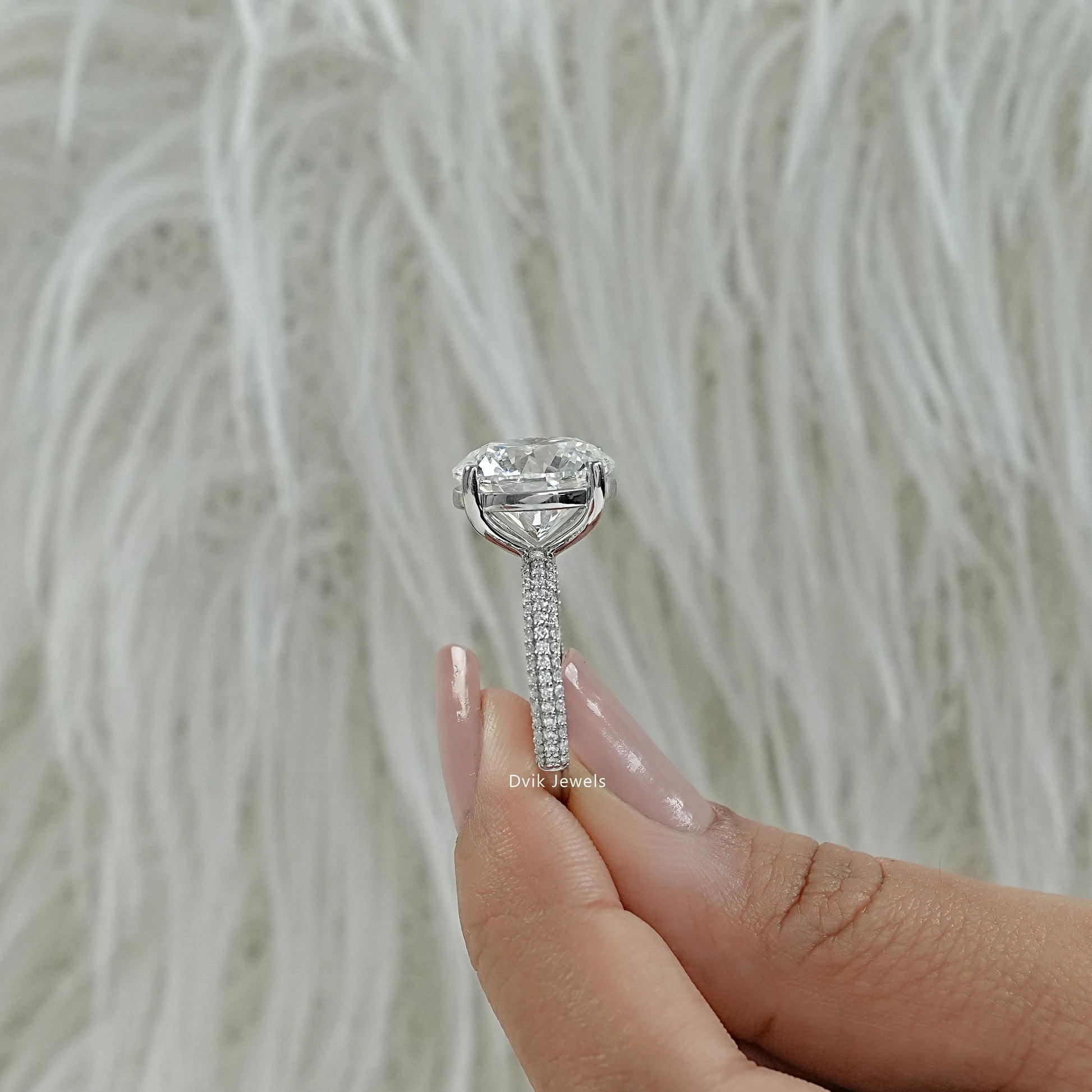 Engagement ring round with side stones and micro pave accents close up view