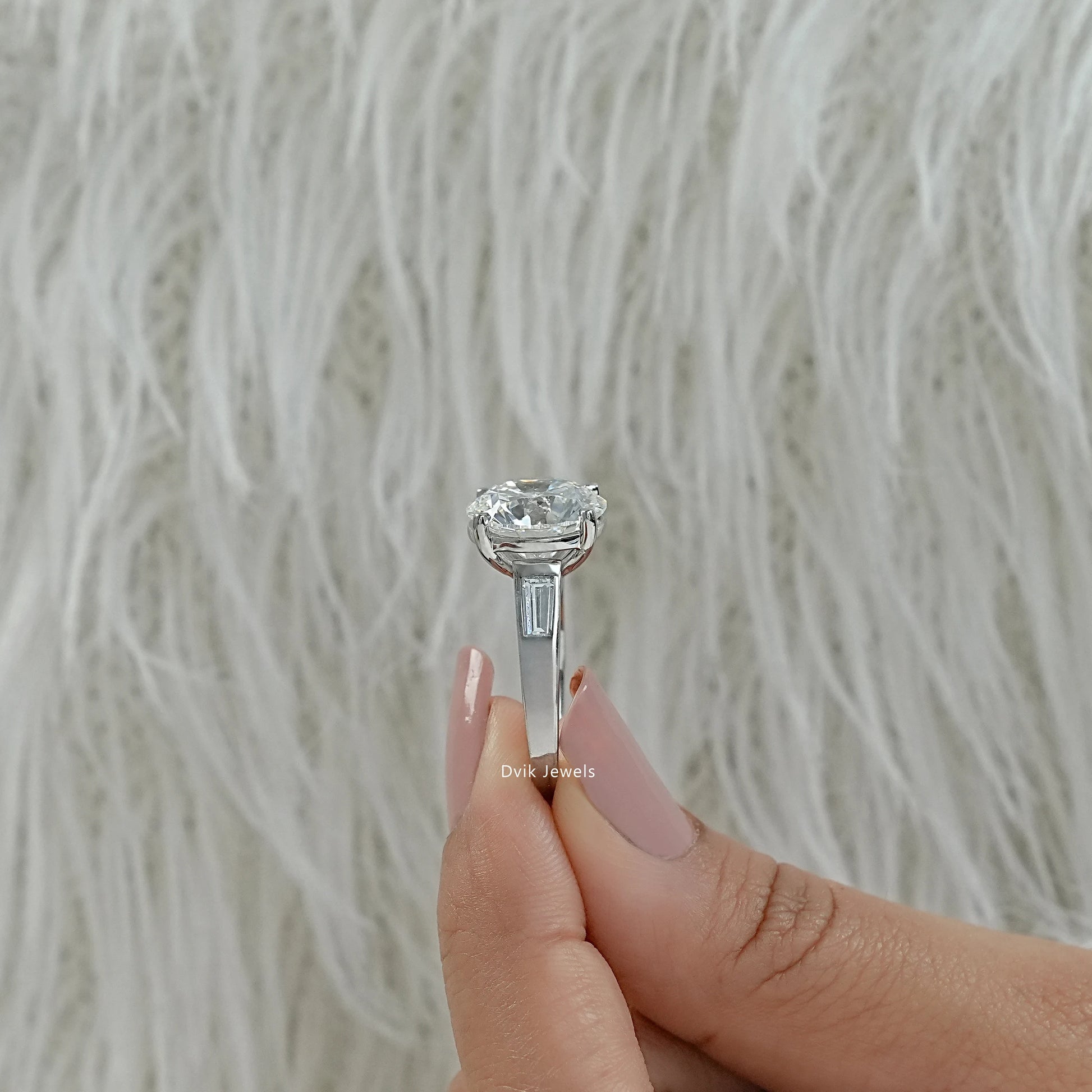 Engagement ring with baguettes on side round lab diamond engagement ring close up