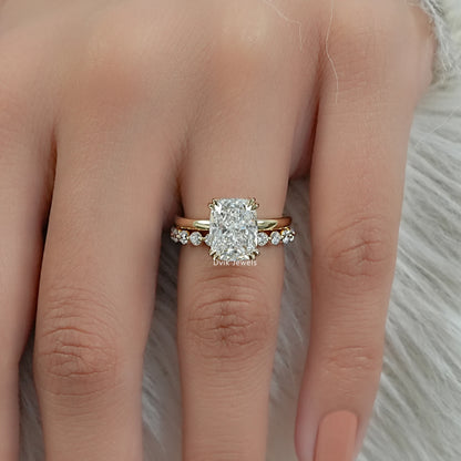 cushion cut engagement rings styled as a bridal set on a hand with nude nails.