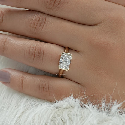 Radiant cut solitaire engagement rings yellow gold bezel on hand