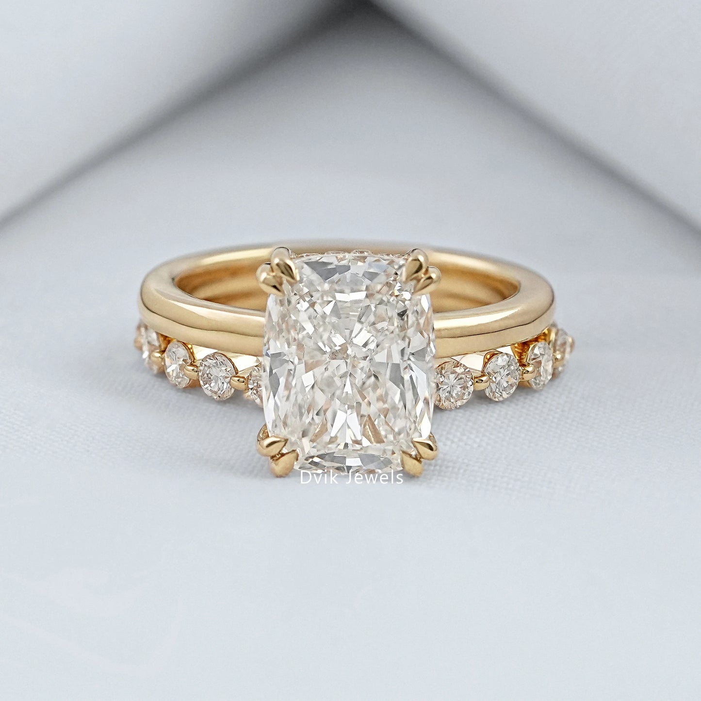 cushion cut diamond ring with a large center stone and a sleek 14k gold band.