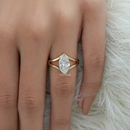Marquise cut engagement ring worn on a finger to showcase the elongated shape