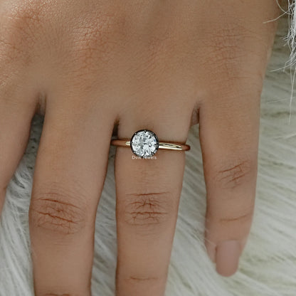 Old mine cut diamond solitaire ring worn on a finger for bridal style.