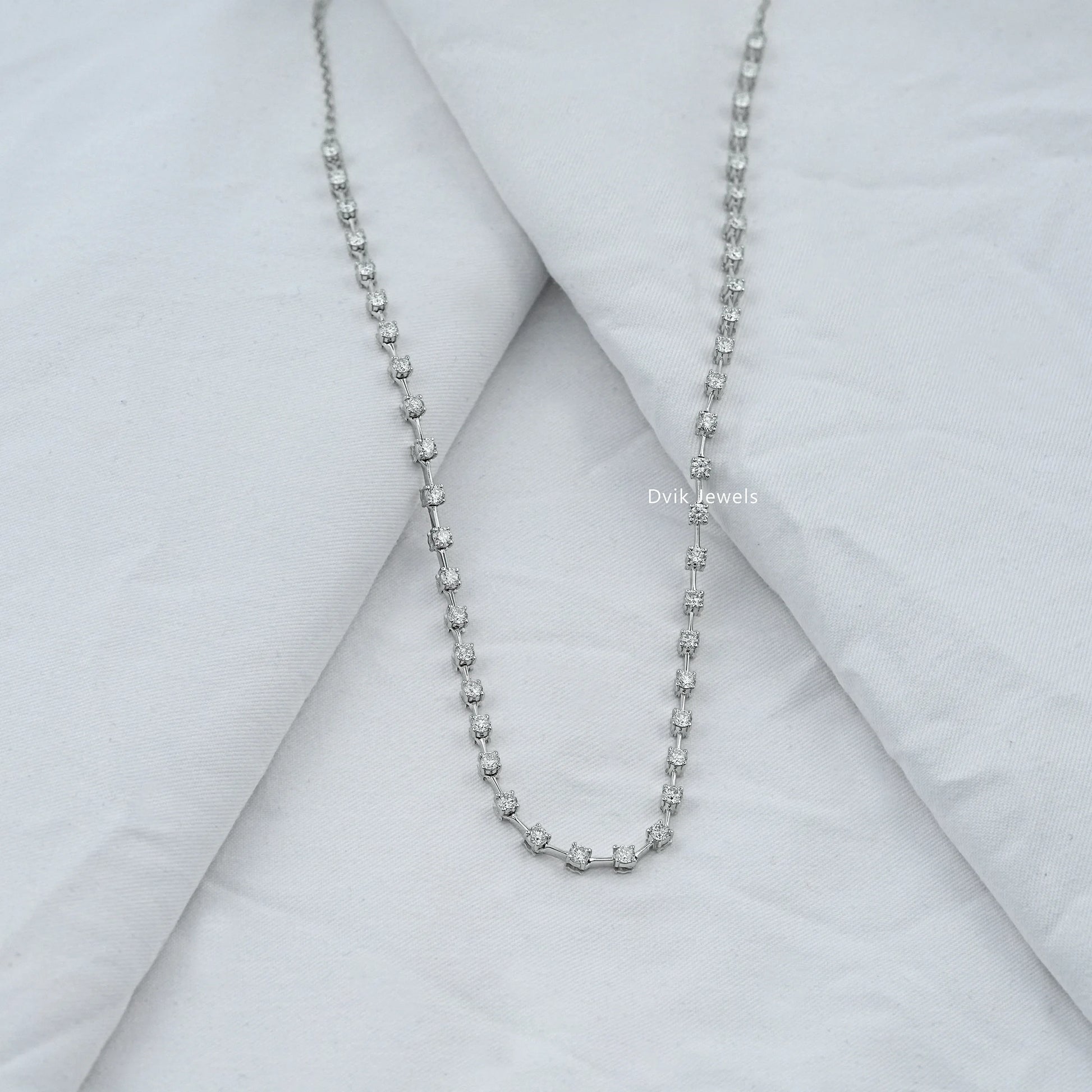 Lab grown graduated tennis necklace worn on a neck to show the bridal fit