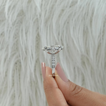 Hidden halo engagement ring oval worn on a hand showing the bridal design