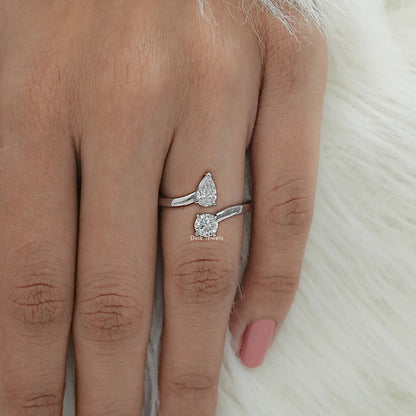 Twin shape bypass ring with pear and round cut diamond worn by women