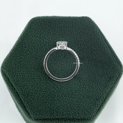 Side profile of pear diamond ring with round-shaped side stones and a delicate high-set basket