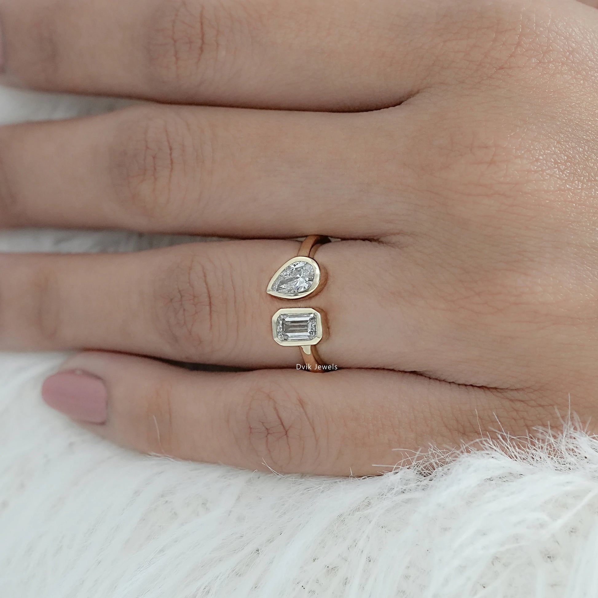 Bezel Set Lab Grown Diamond Toi Moi Ring with Emerald and Pear Cuts worn on finger