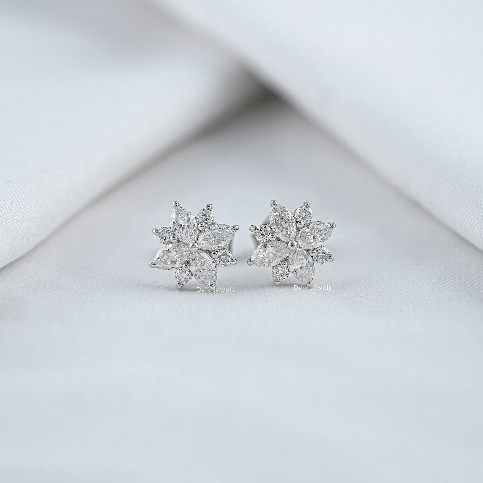 Floral shaped diamond stud earrings with marquise and round cuts