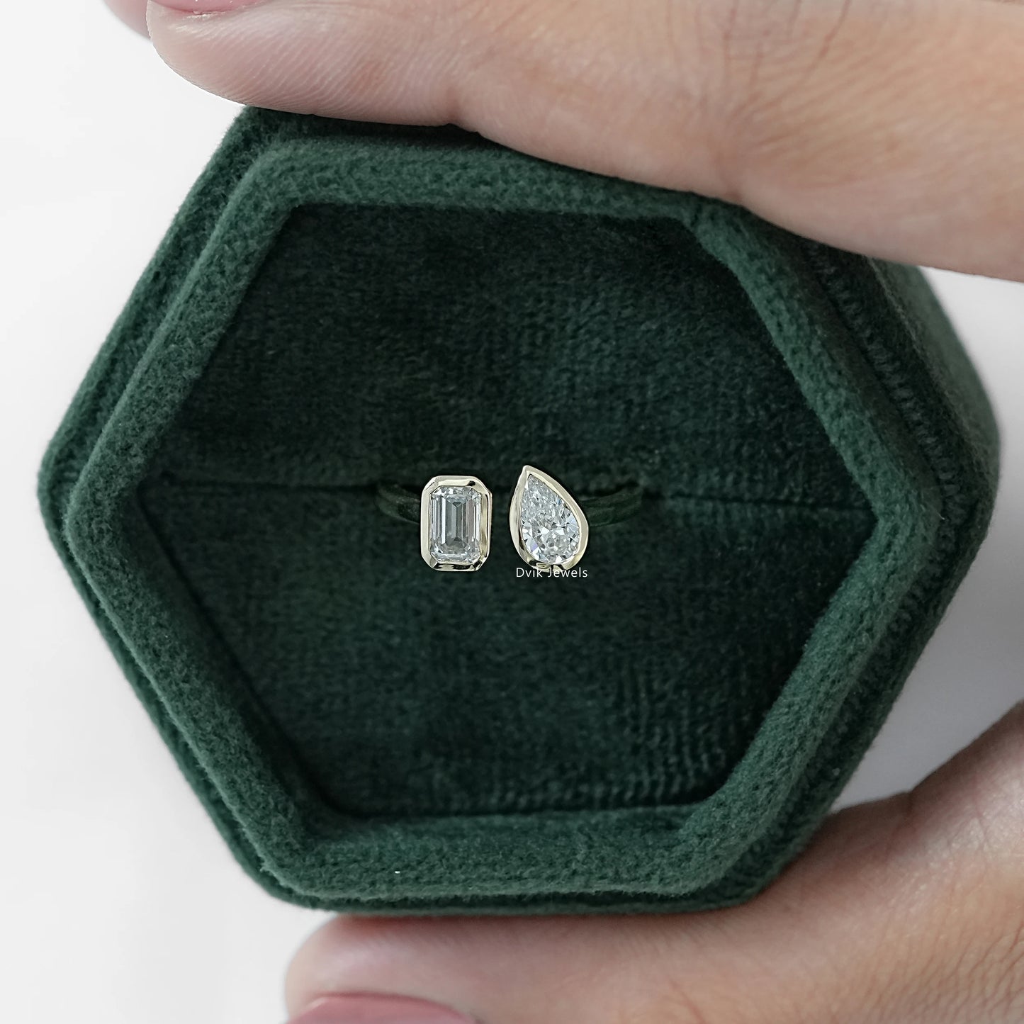 Lab Diamond Emerald and Pear Cut Bezel Toi Moi Ring displayed in jewelry box front view