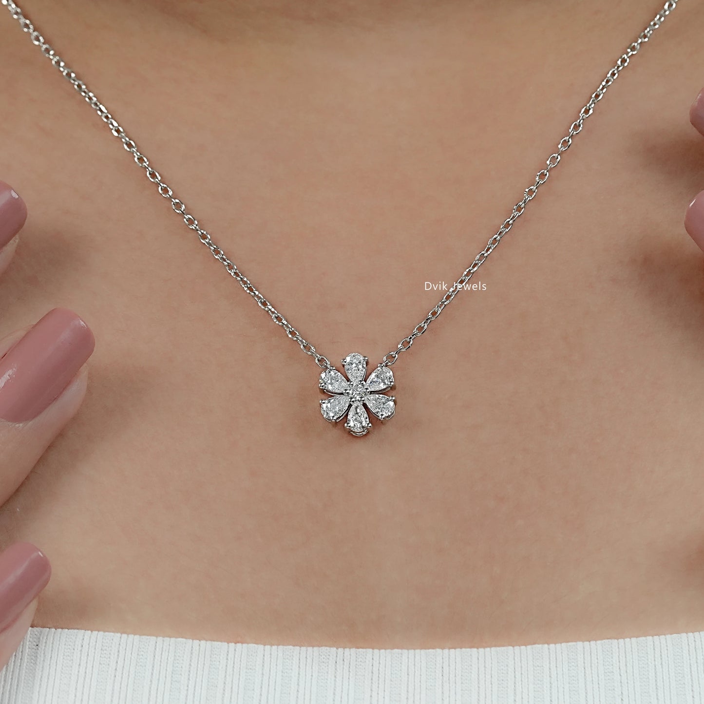 Women wear lab diamond floral pendant to display how flower design sits on neckline