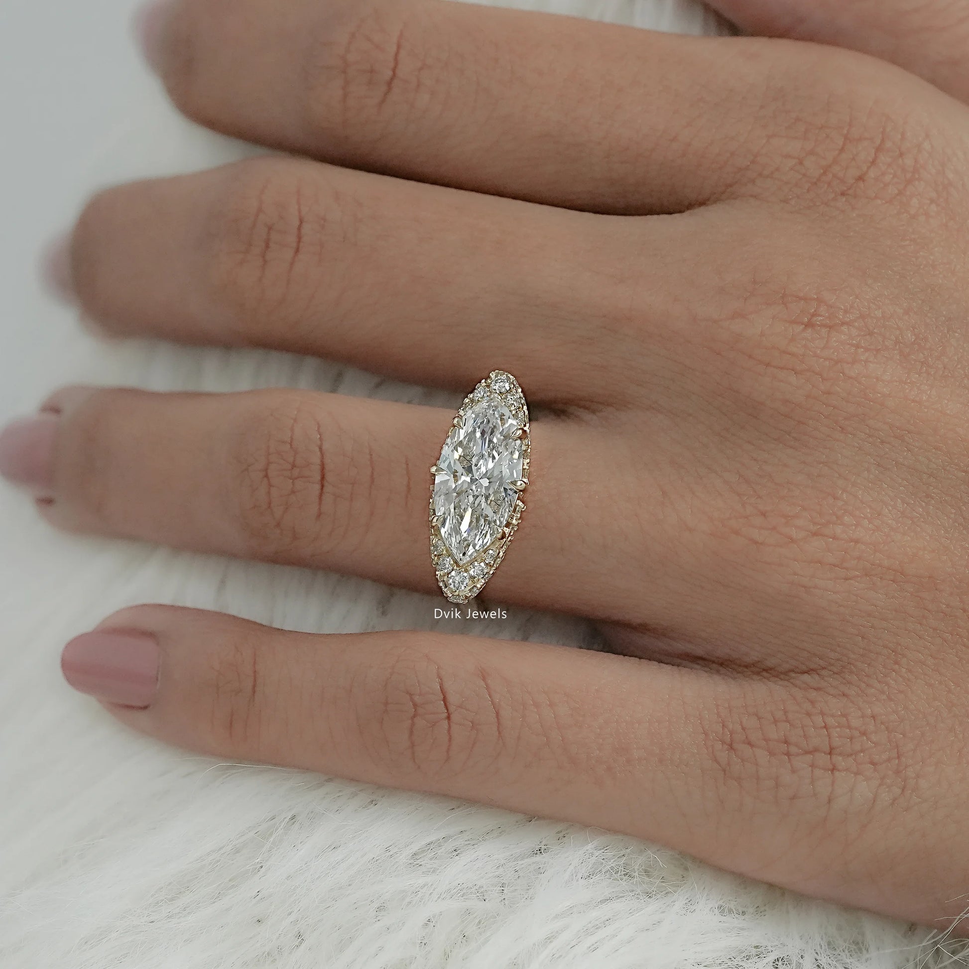 Women wear lab grown diamond marquise engagement ring with yellow gold band