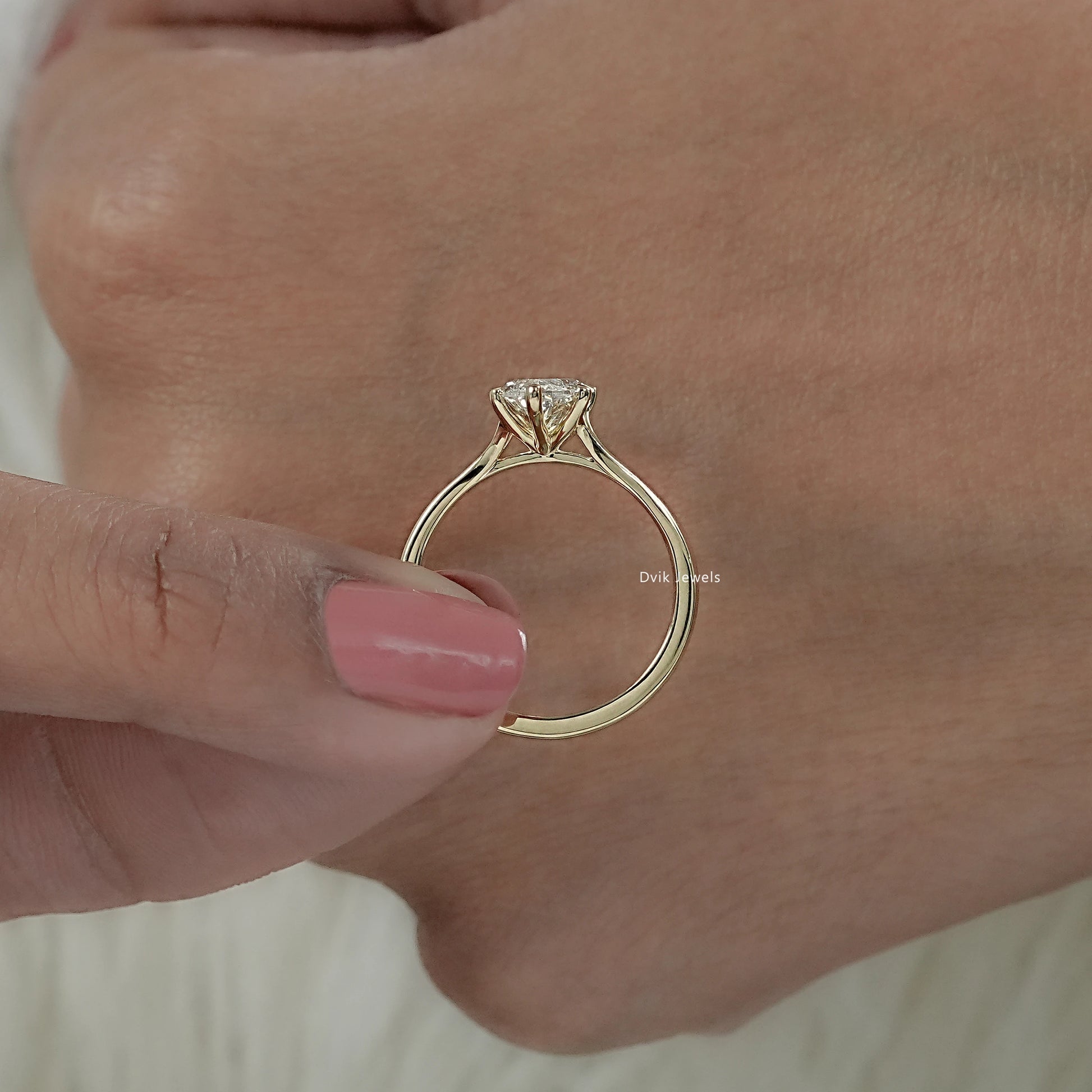 Detailed view solitaire engagement ring with marquise diamond