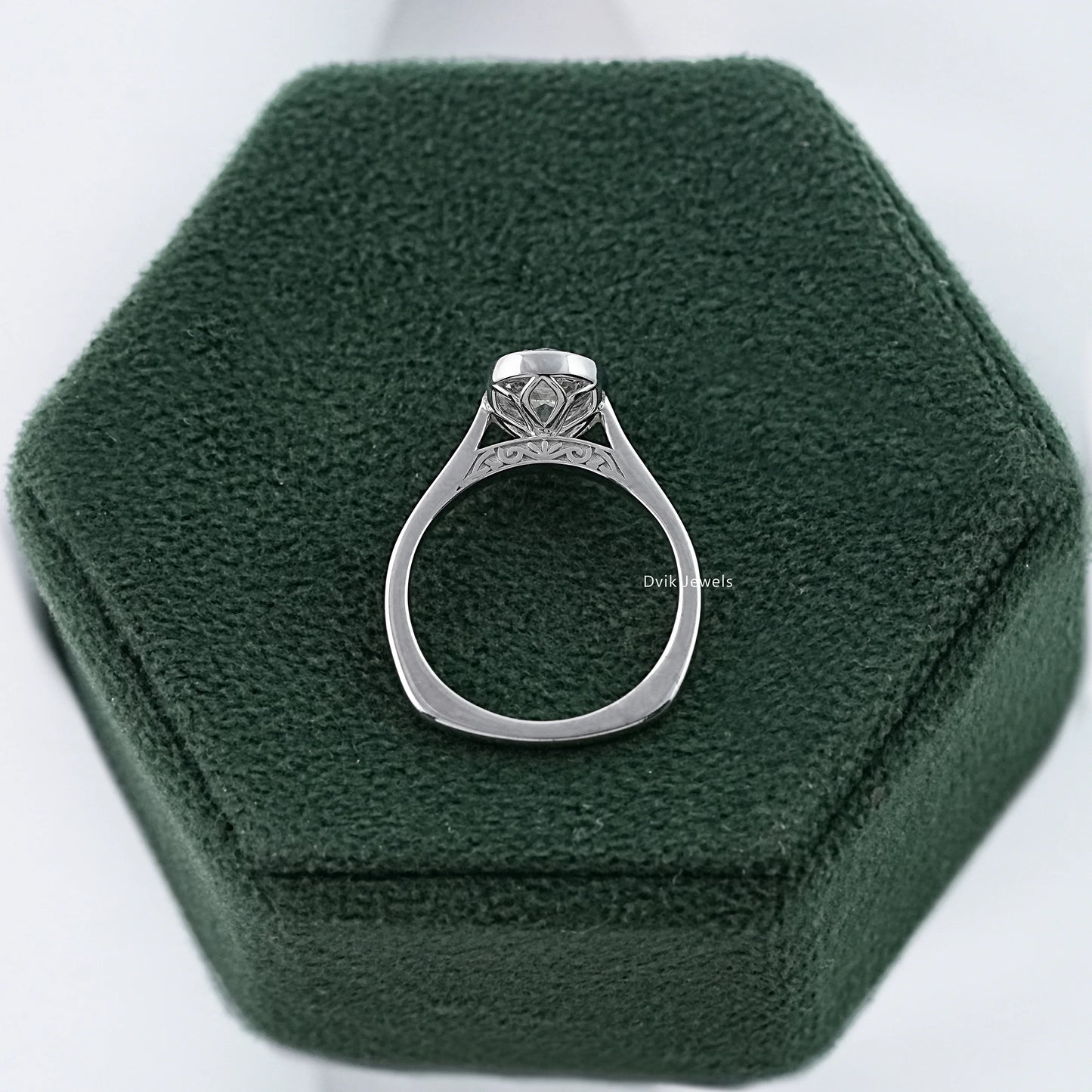 Side profile of old mine cushion cut diamond ring in sleek bezel setting displayed gallery detail and polished band