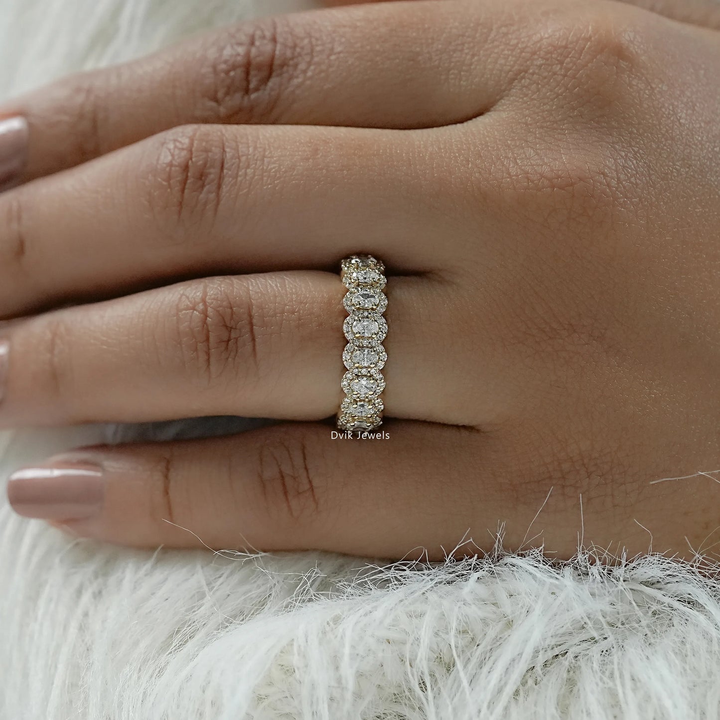 Oval cut diamond wedding band with a unique halo cluster design.